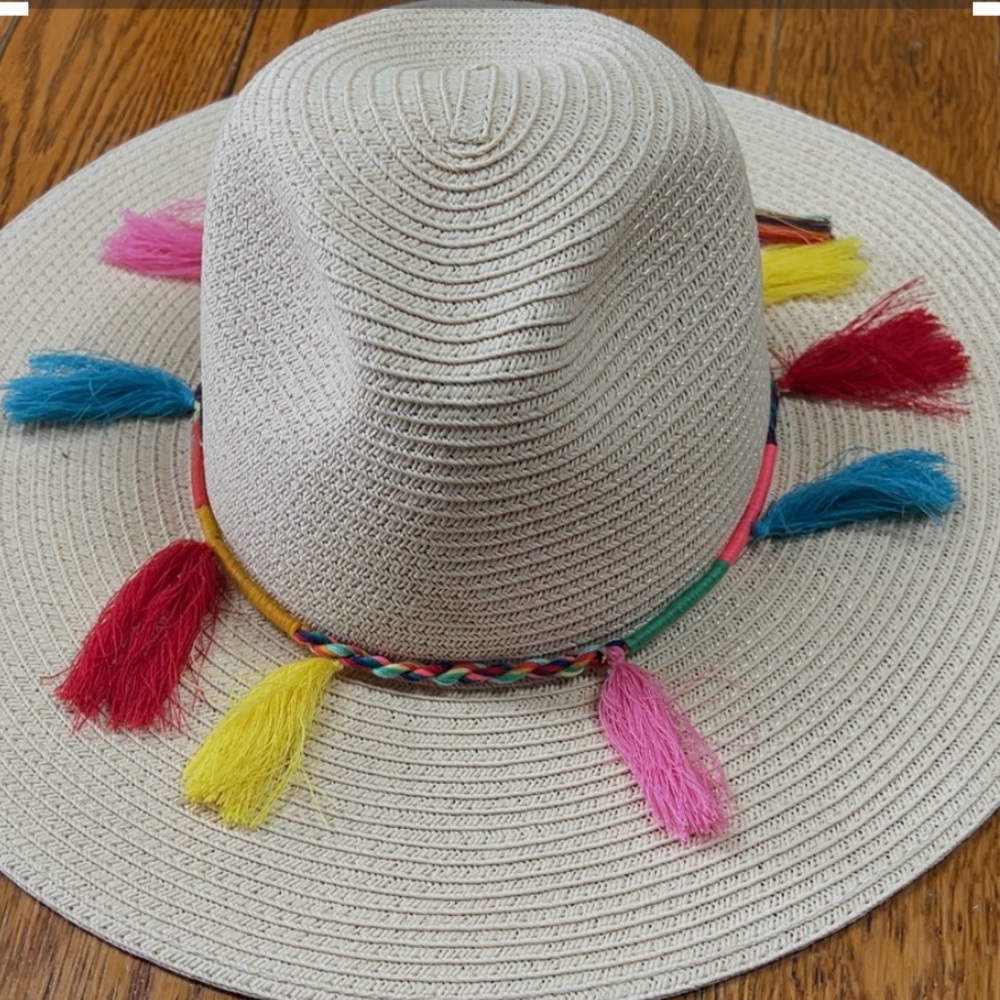 Sun ‘N’ Sand light tan straw hat with colorful tassels around brim. One size.